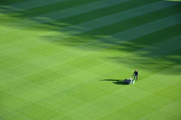 Man mowing a baseball field